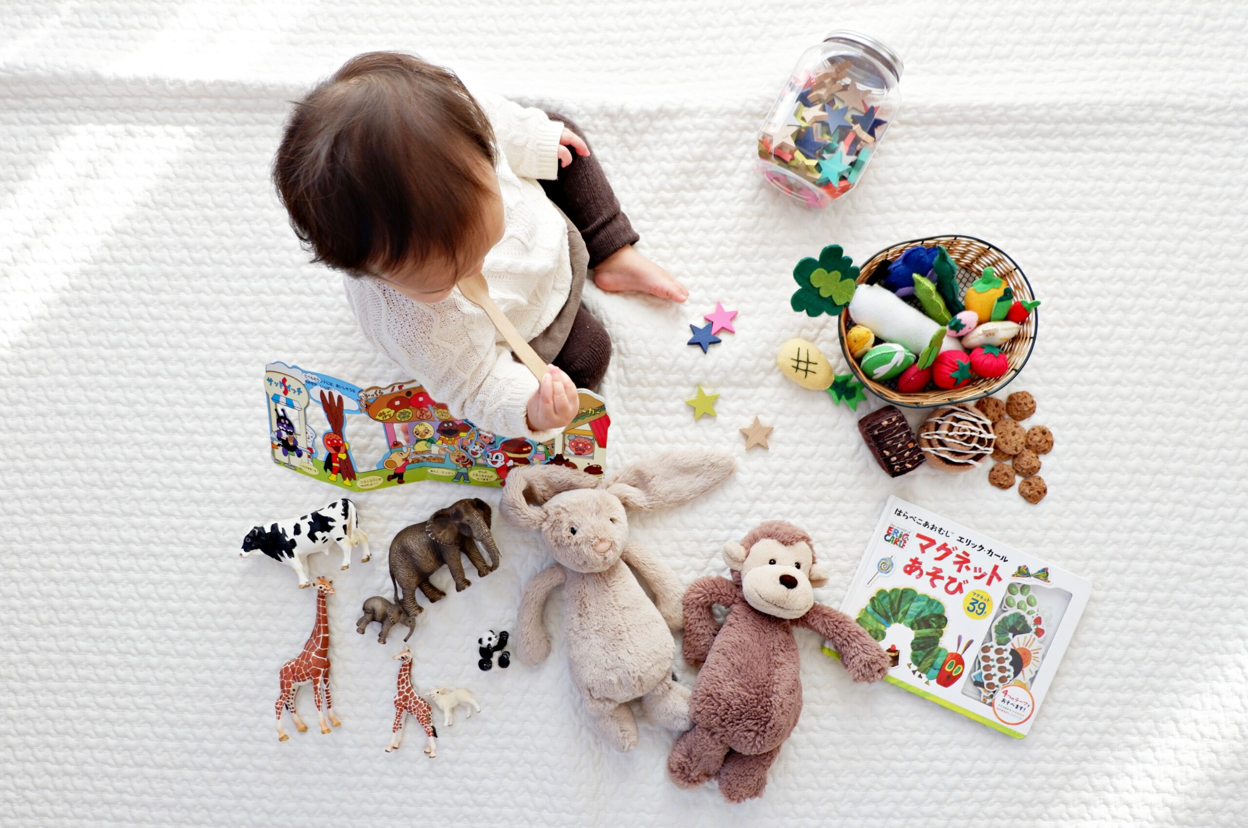An image showcasing a colorful Montessori toy shelf filled with wooden blocks, puzzles, and sensory materials